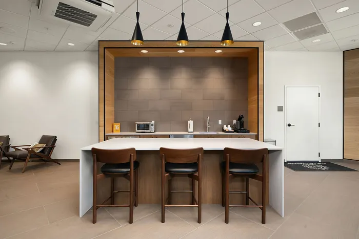 Modern kitchen area with a stylish island, sleek appliances, and elegant pendant lighting, perfect for entertaining.