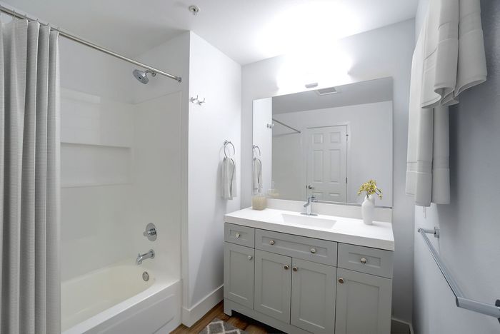 Elegant bathroom design featuring a modern vanity with ample storage, sleek fixtures, and bright lighting for a fresh, airy feel.