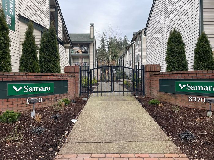 Inviting entrance to Samara Apartments, featuring well-maintained pathways and lush greenery, offering a serene living environment.