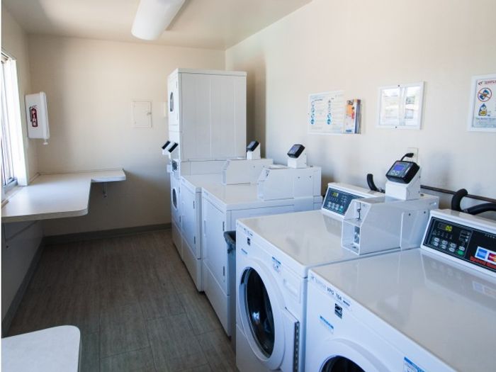 Convenient On-Site Laundry Center featuring Brand New Washers and Dryers