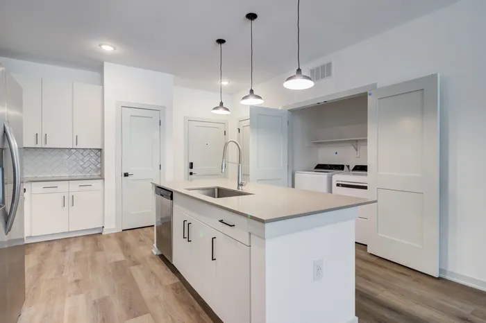 kitchen-island-dishwasher-sink-washer-dryer-pantry-pendant-lighting-garrett-forum-apartments-fort-myers-florida.jpg