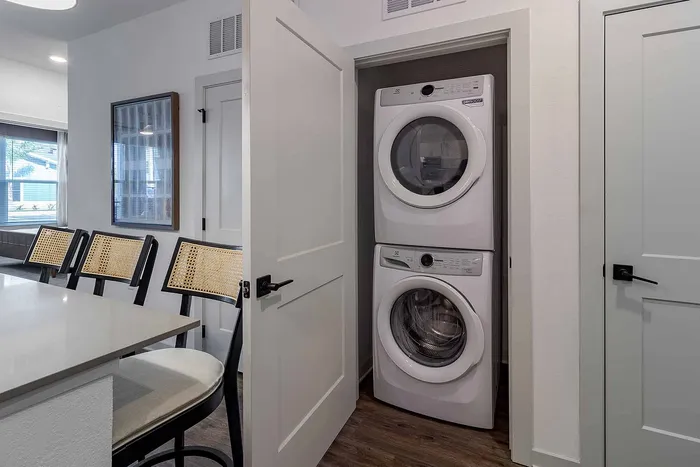 In-unit stacked Electrolux washer and dryer in a closet at Garrett Gateway apartments in Fort Myers, FL