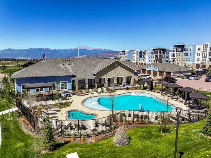 Resort-style pool and spa with shaded cabanas and Pikes Peak views at The Baldwin Modern Apartments in Colorado Springs, CO