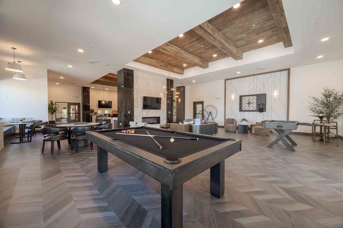 Billiards table and lounge seating in the Garrett Parker apartments clubhouse in Parker, CO