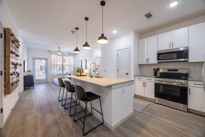 Kitchen with island seating in the Garrett Parker B1 floor plan apartment in Parker, CO
