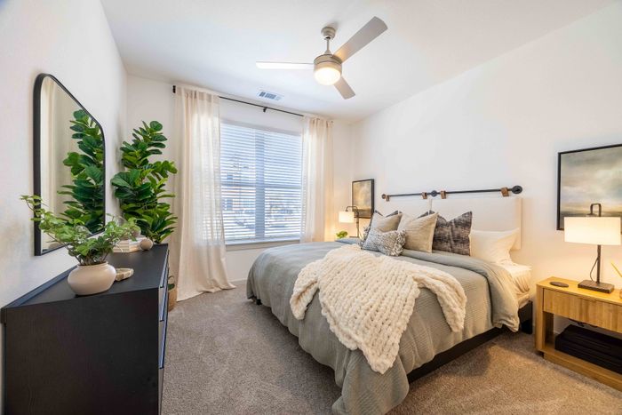 Primary bedroom with queen bed in the Garrett Parker B1 floor plan
