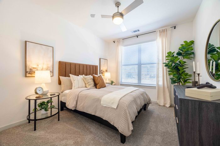 Secondary bedroom with queen bed in the Garrett Parker B1 floor plan