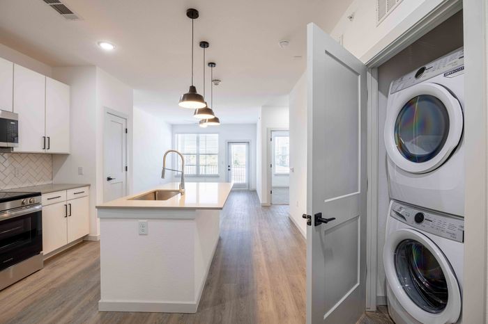 Kitchen with stacked washer and dryer in the Garrett Parker A1 floor plan