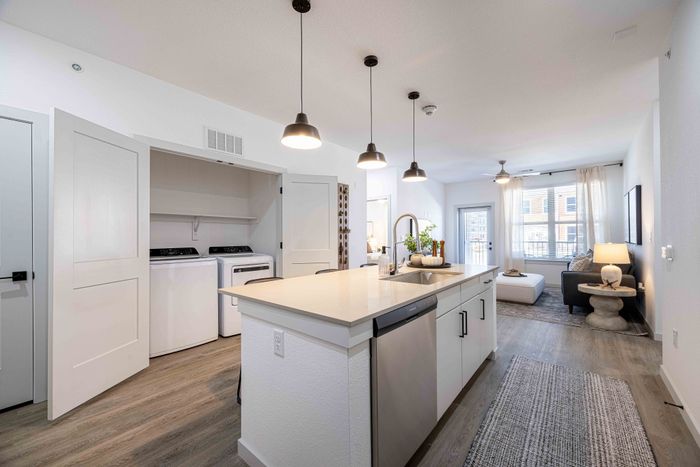 Kitchen island with in-unit laundry closet in the Garrett Parker B1 floor plan