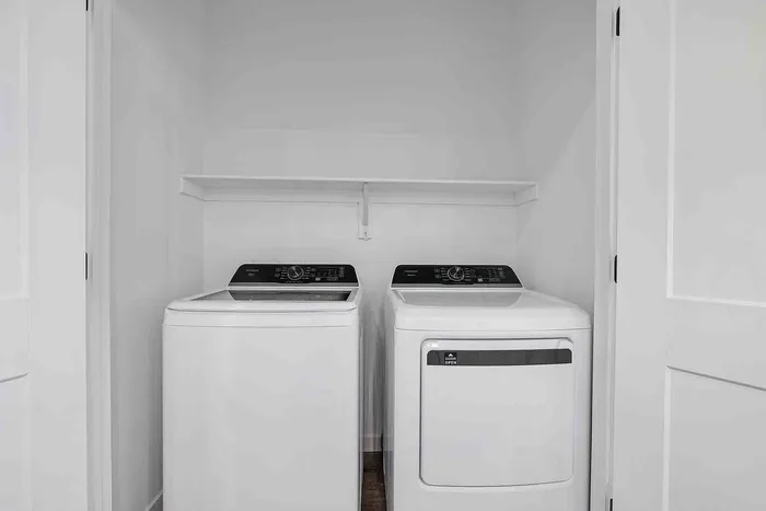 Full-size side-by-side washer and dryer in the in-unit laundry closet of the B1 two-bedroom at Garrett Fillmore.