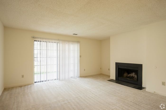 Bright living room with large sliding doors and a modern fireplace.