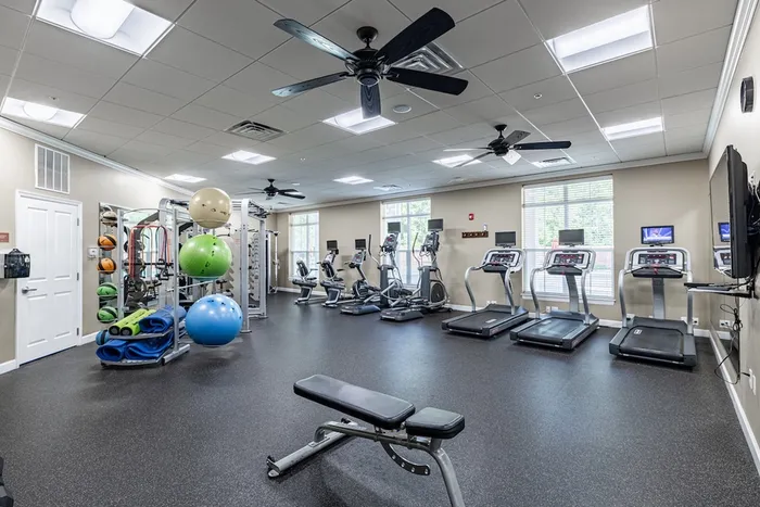 Modern fitness center equipped with treadmills, exercise bikes, and vibrant workout gear, perfect for energizing workouts.