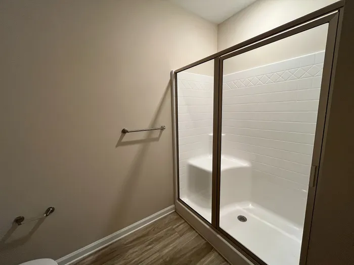 Sleek modern bathroom with a glass-enclosed shower and elegant tile design.