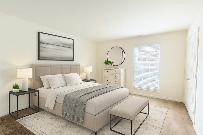 Elegant bedroom featuring a plush beige bed, cozy nightstands with lamps, and stylish decor including a round mirror and framed art.