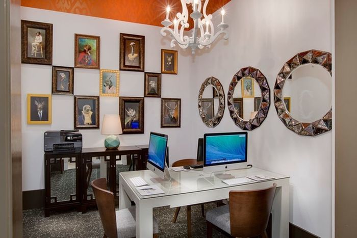 Photo of business center with 3 computers and 1 printer.