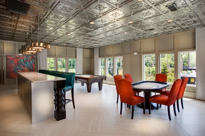 Photo of recreation room with card table, pool table, and serving bar.