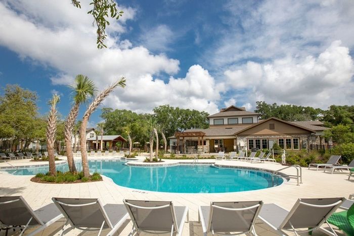 Photo of community pool with outdoor seating.