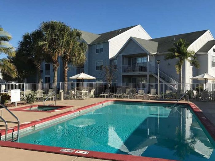 Serene swimming pool and building | The Gables at Lakeside Kissimmee, FL