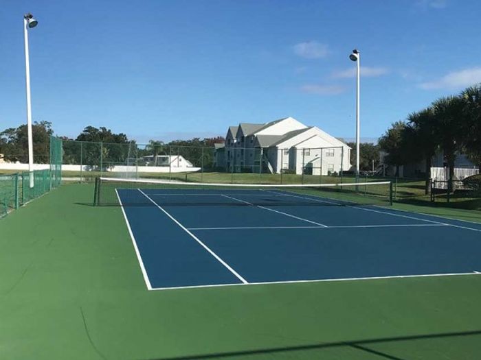 Blue tennis court and building