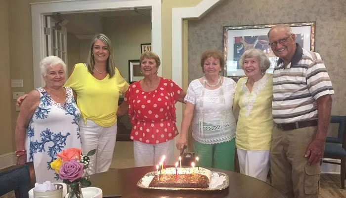Group celebrating with cake Sandalwood Village | Naples FL