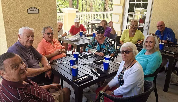 Seniors dining on the terrace Sandalwood Village | Naples FL