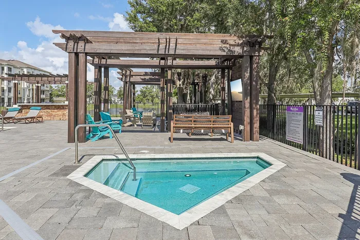 Luxurious outdoor area featuring a serene hot tub under elegant wooden pergolas, surrounded by stylish seating and lush greenery.