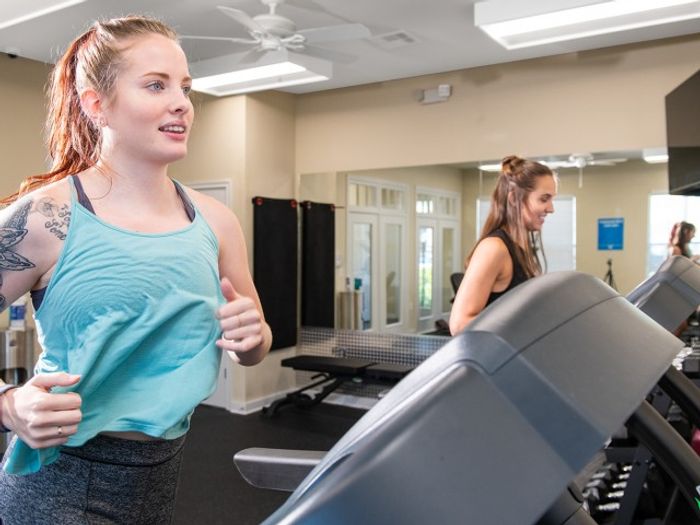Residents using treadmills in the fitness center at Eagle Flatts Apartments in Hattiesburg, MS.