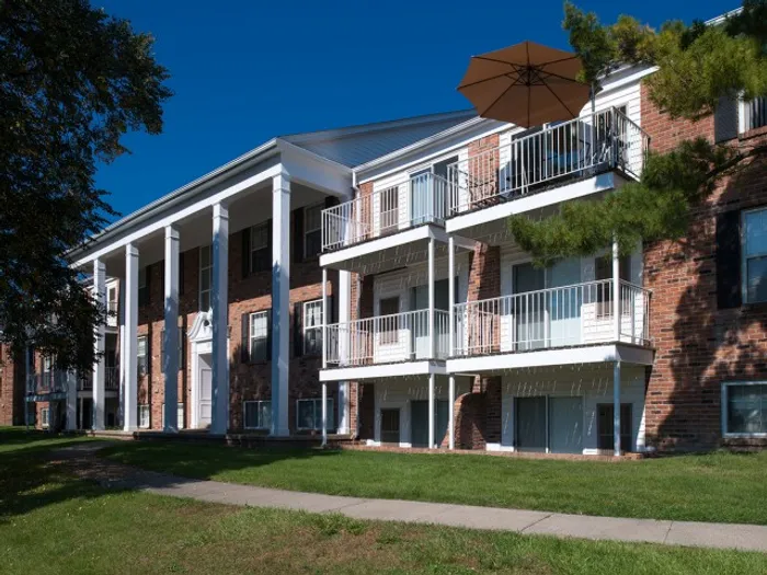 Exterior view of University Hills Apartments with private balconies and classic brick architecture near the University of Toledo