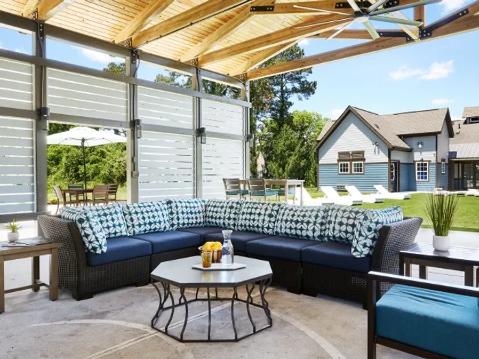 Vibrant outdoor lounge with vaulted ceiling, slatted walls, and ceiling fan at The Flatts Salisbury