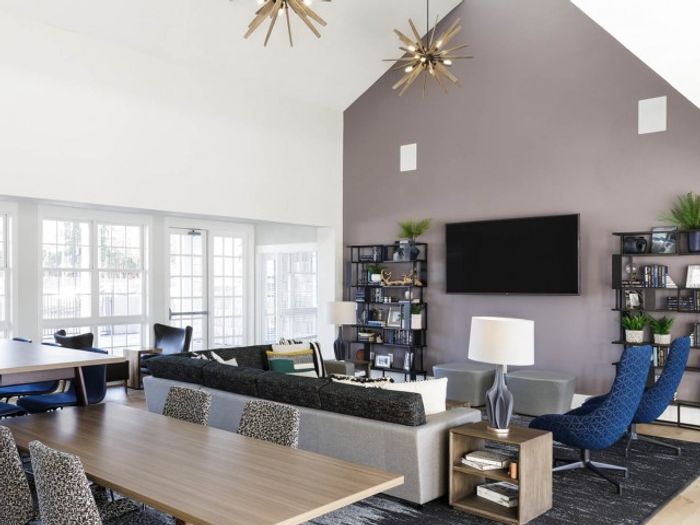 Spacious clubhouse with media entertainment center and meeting tables at The Flatts Salisbury