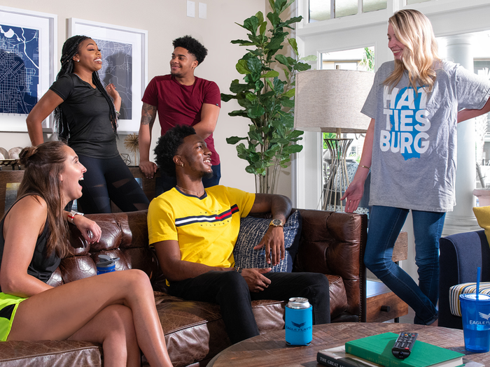 Residents socializing in the clubhouse lounge at Eagle Flatts Apartments in Hattiesburg, MS.