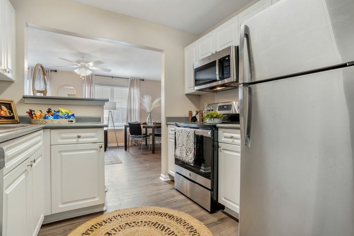 Kitchen with pass-through counter and stainless-style appliances at Theater Street Apartments in Lafayette, LA
