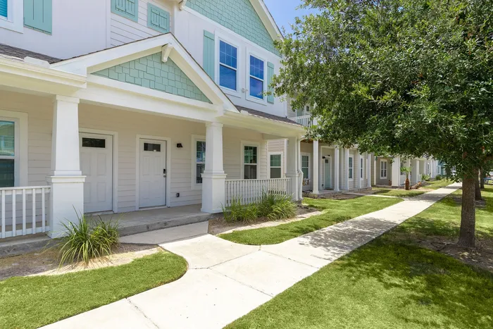 Beautiful exterior view of townhomes with porches at Seaglass Apartments in Corpus Christi