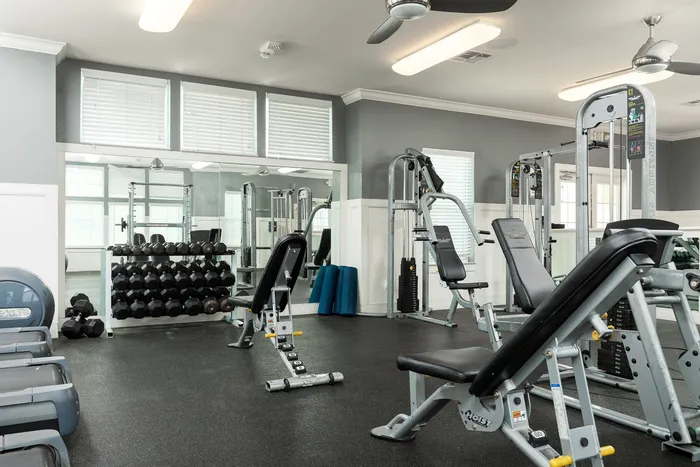 Free weights and strength training equipment in the fitness center at Seaglass Apartments in Corpus Christi
