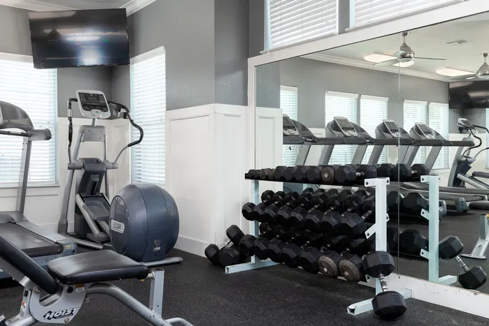Cardio machines and free weights in the fitness center at Seaglass Apartments in Corpus Christi
