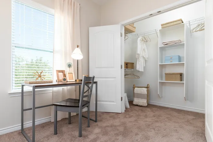 Bedroom workspace with natural light and walk-in closet at Seaglass Apartments in Corpus Christi