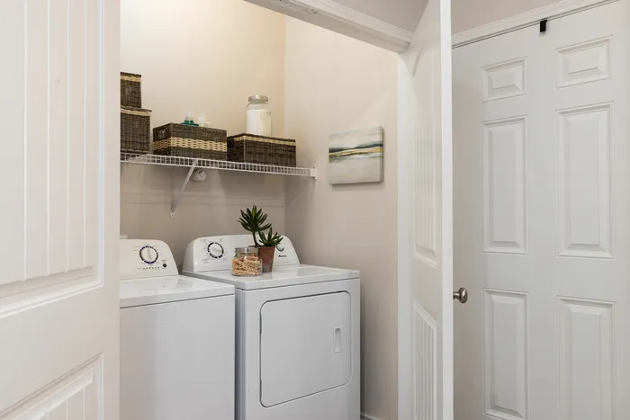 In-home laundry room with washer and dryer at Seaglass Apartments in Corpus Christi