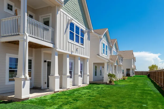 Back view of townhomes with private patios and balconies at Seaglass Apartments in Corpus Christi