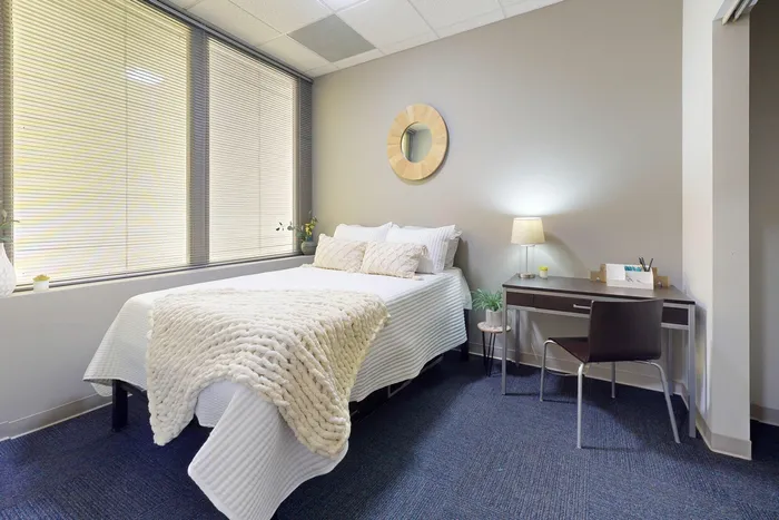 Comfortable bedroom with a dedicated study area in University Plaza off-campus apartments near NIU