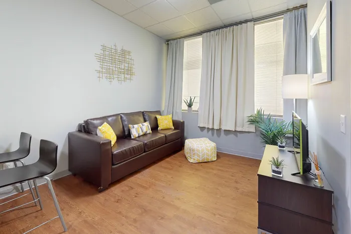 A4 Living room with lots of natural light in University Plaza student apartments near NIU