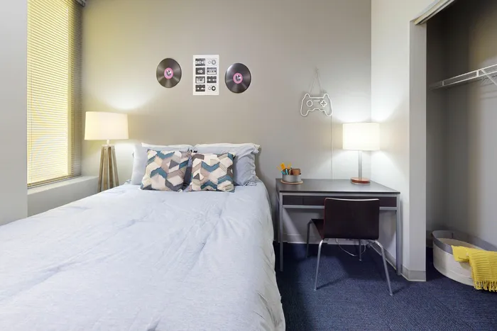 Spacious bedroom with carpet flooring in University Plaza off-campus apartments near NIU