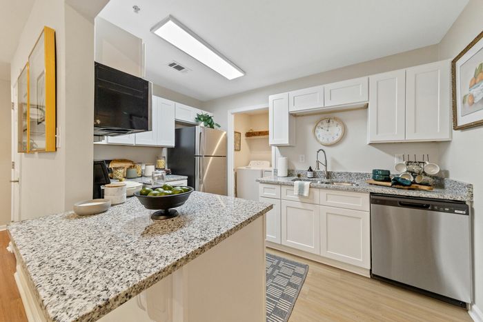 Modern kitchen with wood-style flooring, and stainless-style appliances
