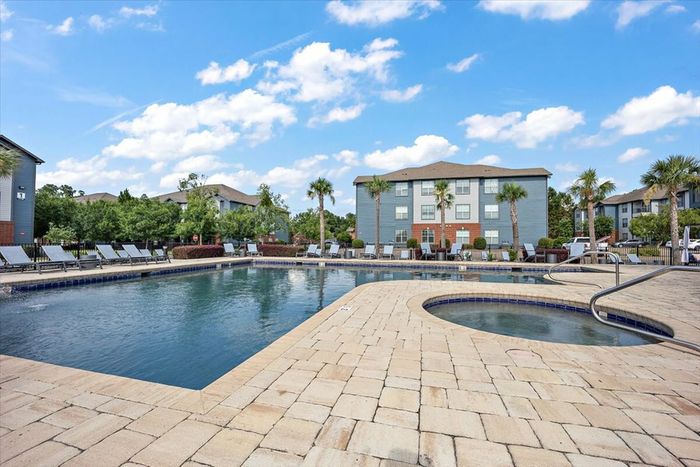 Resort-style pool and hot tub at Eagle Flatts Apartments in Hattiesburg, MS