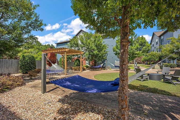 Relaxing hammock garden at Eagle Flatts Apartments in Hattiesburg, MS with shaded seating areas.
