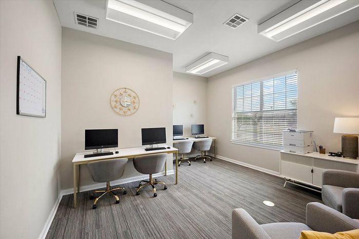 Modern business center at Eagle Flatts Apartments in Hattiesburg, MS with computers and a free printing for resident use.