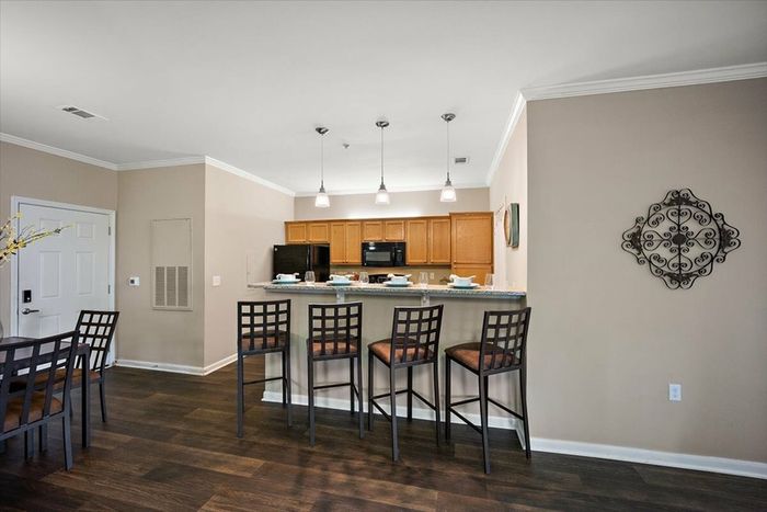 Open-concept kitchen with breakfast bar seating at Eagle Flatts Apartments in Hattiesburg, MS.