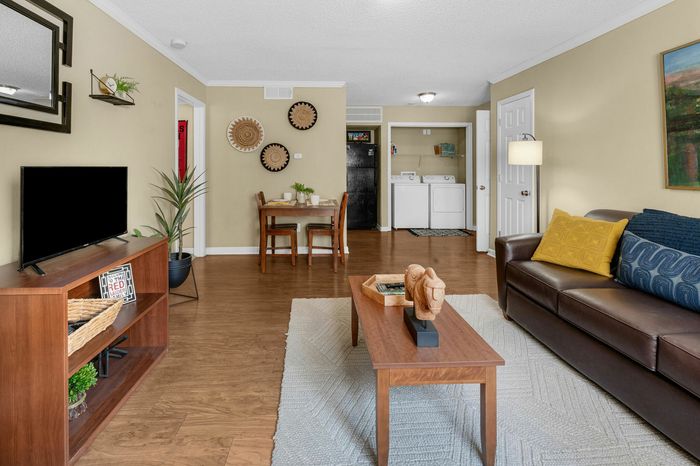 Spacious Living Room with modern furniture and Washer and Dryer