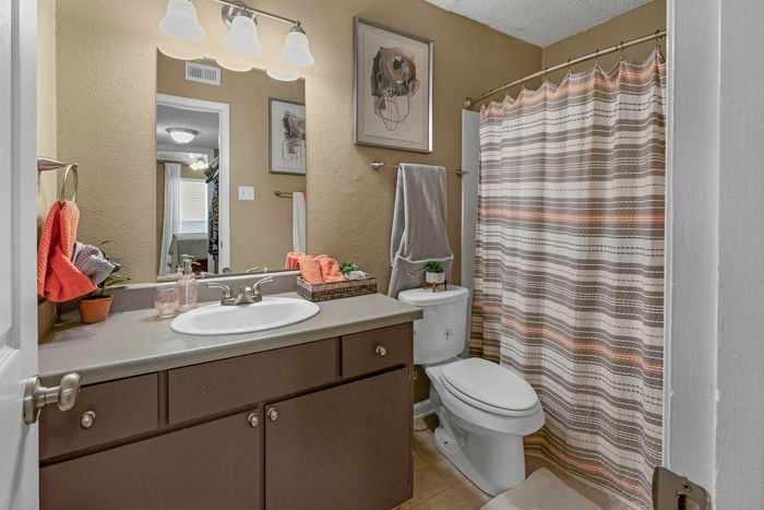 Private bathroom featuring linen closet