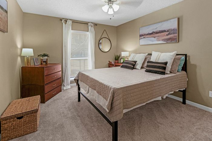 Modern bedroom with ample natural light at Raiders Walk apartments