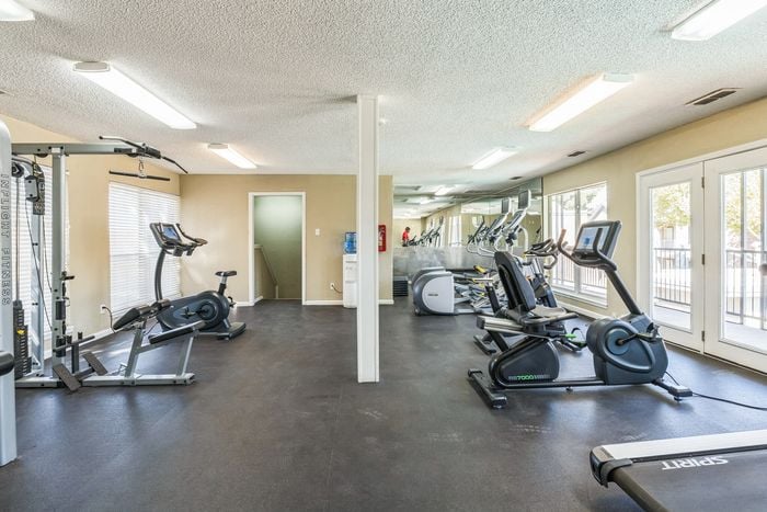 Fully equipped fitness center at Raiders Walk with a variety of exercise machines and free weights